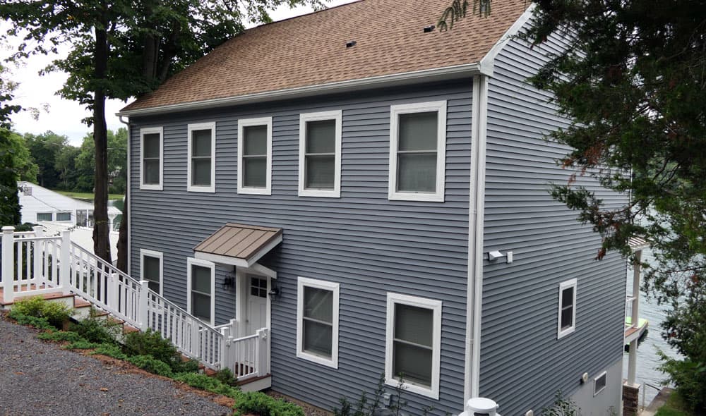 Two-story house with gray vinyl siding and white-trimmed windows