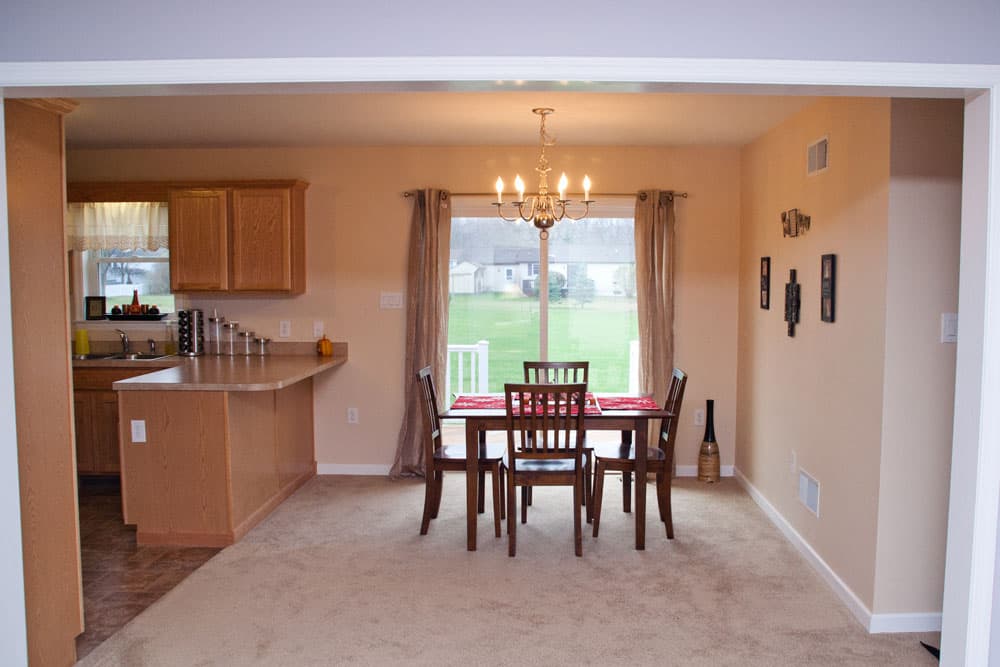 Open concept kitchen and dining area with wood cabinetry and patio door